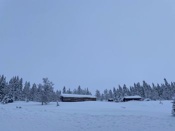 Scenic view of snow covered field against clear sky