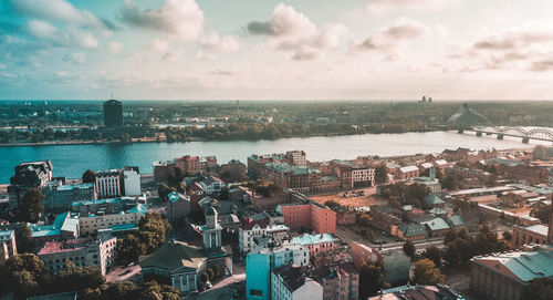 High angle view of townscape by sea against sky