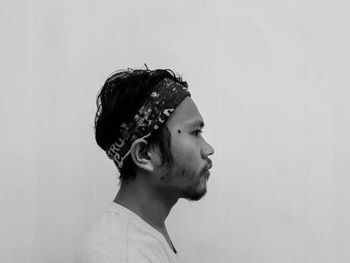 Portrait of young man against white background