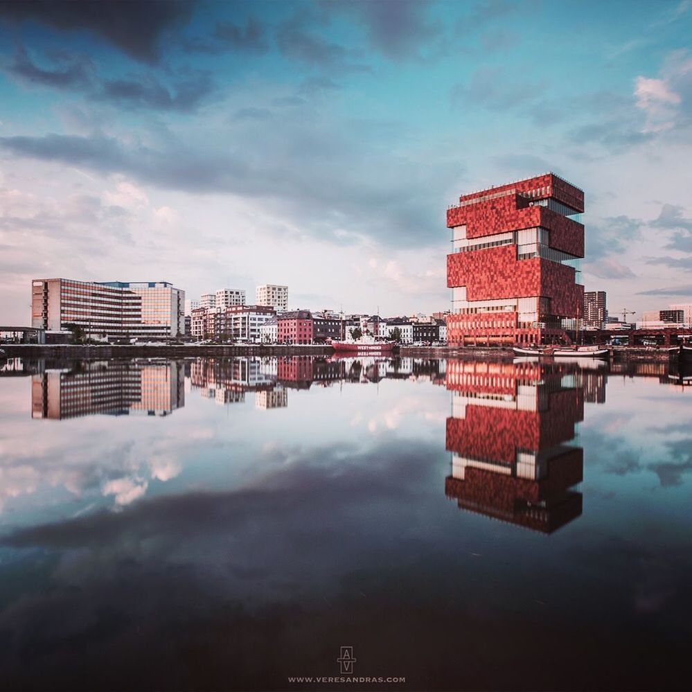 architecture, building exterior, built structure, cloud - sky, sky, reflection, water, waterfront, building, city, nature, no people, outdoors, residential district, symmetry, day, river, cityscape, office building exterior, apartment