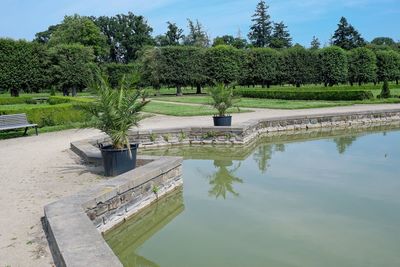 Scenic view of swimming pool by lake against sky