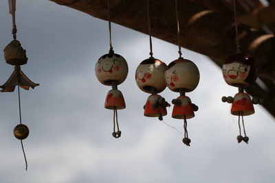 Low angle view of lanterns hanging against sky