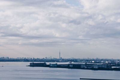 View of boats in sea against cloudy sky