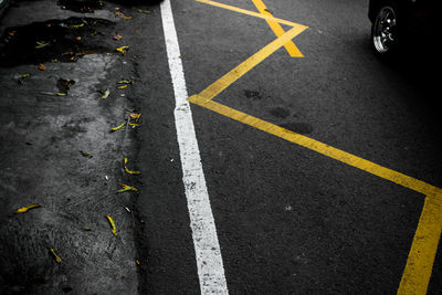 High angle view of arrow symbol on road in city