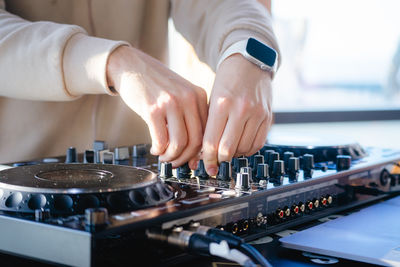 Cropped hand of man playing piano