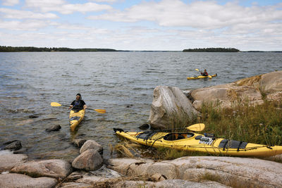 People in kayaks paddling to shore