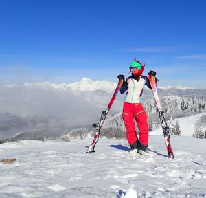 Woman skiing on snow covered mountain