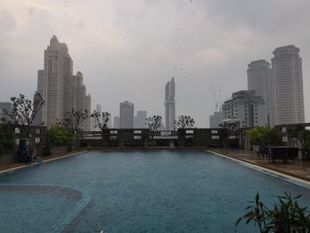 View of swimming pool with buildings in background