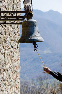 Cropped hanging ringing bell