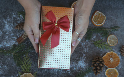 Cropped hands of woman holding christmas presents