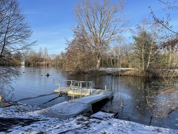 Scenic view of lake against sky during winter