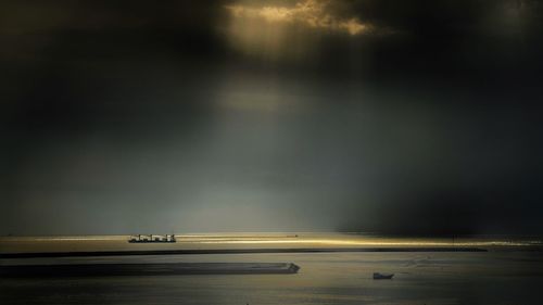 Scenic view of sea against sky at dusk