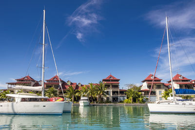 Luxury yachts and boats in sunny summer day at marina of eden island, mahe, seychelles