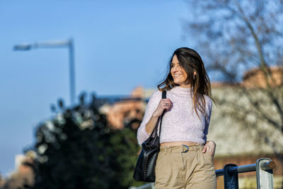 Smiling woman standing in city