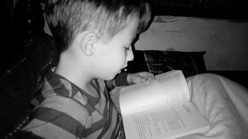 Close-up of boy on sofa at home