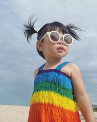 Portrait of woman wearing sunglasses against sky