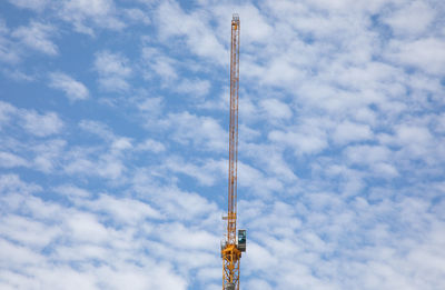 Low angle view of crane against sky