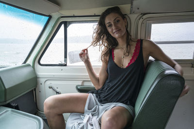 Portrait of smiling woman sitting in bus