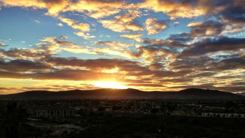 Scenic view of landscape against cloudy sky