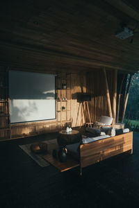 Chairs and tables against sky seen through window