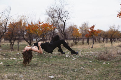 Woman on bare tree