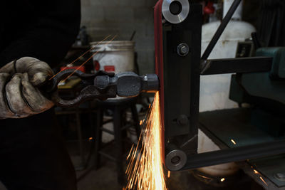 Midsection of man working in factory