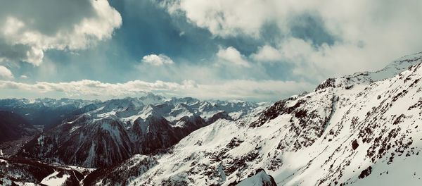 Panoramic view of snowcapped mountains against sky