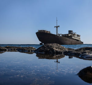 Ship on sea against clear sky