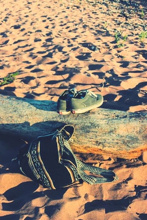 sand, sunlight, beach, shadow, high angle view, nature, day, outdoors, tranquility, beauty in nature, leisure activity, rock - object, lifestyles, water, shore, sunny, pattern, tranquil scene