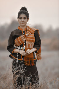 Portrait of young woman standing outdoors