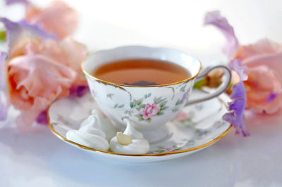 Close-up of tea cup with flowers on table