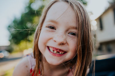 Close up of happy little girl missing a front tooth