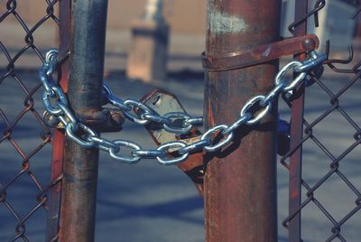 Close-up of padlock on rusty metal gate