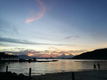 Scenic view of lake against sky at sunset