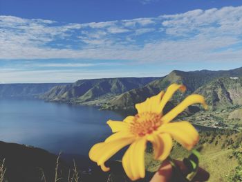 Scenic view of sea and mountains against sky