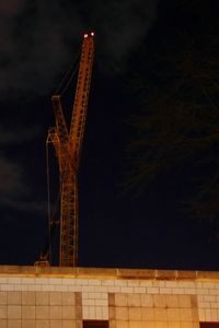 Low angle view of built structure against sky at night