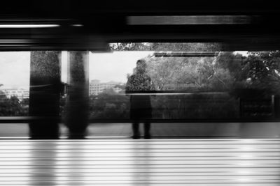 Blurred motion of man walking on train window