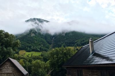 Low angle view of house on mountain against sky