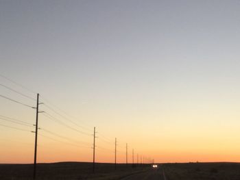 Road against clear sky during sunset