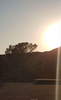 Scenic view of landscape against clear sky during sunset