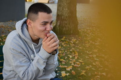 Portrait of young man sitting outdoors