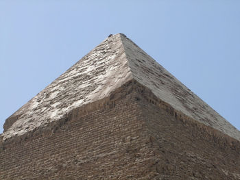 Low angle view of historical building against clear blue sky