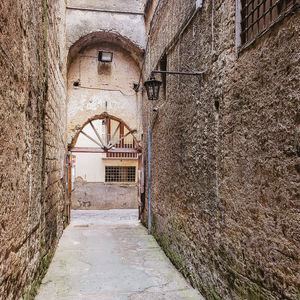 Old stone brick alley to arch doorway
