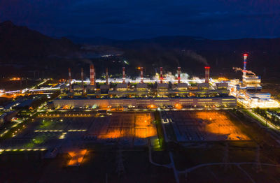 High angle view of illuminated city against sky at night