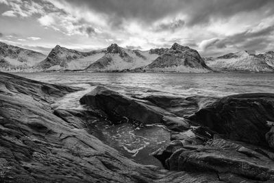 Scenic view of sea and mountains against sky