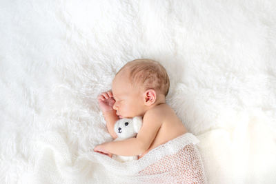 Cute baby girl sleeping on bed