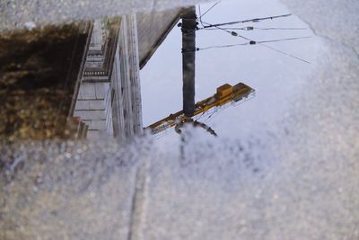 Low angle view of snow on house window during winter