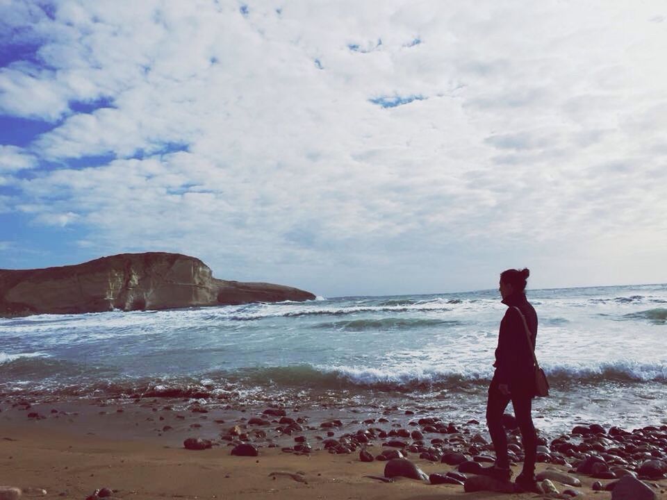 sea, beach, shore, horizon over water, water, leisure activity, sky, lifestyles, vacations, standing, cloud - sky, rear view, sand, scenics, person, beauty in nature, men, nature