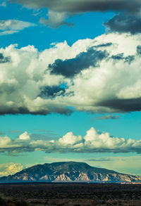 Scenic view of mountains against blue sky