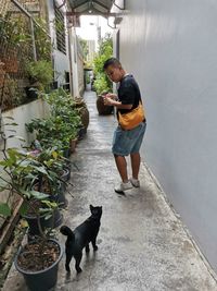 Full length of woman standing with dog